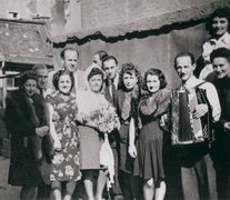 Oskar Schindler (4th from left) with some of those he rescued, including Leo Rosner (with accordion), Munich, 1946.