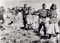 ELAS partisans including Salvator Bakolas (2nd from right) in partisan uniforms with rifles, Parnitha Mountains, 1944.