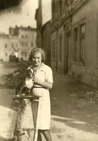 Irena Droździkowska with her dog Szerusia inside the Kraków ghetto, after it was liquidated in March 1943.