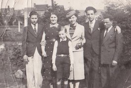 Perla and Sigmund Aufrychter (2nd from left and 1st from right) with their sons Bernard, Charles, and Lajbus (left to right) and Lajbus Aufrychter’s wife Lucie (4th from left) in the garden of their house in Charleroi, around 1939.