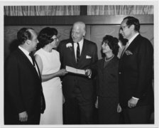 Michael and Irene Feit, Eberhard Helmrich, Susanne Altmann, and the German consul general (left to right) presenting plane tickets to Israel on the occasion of Helmrich’s recognition by Yad Vashem, 1967.