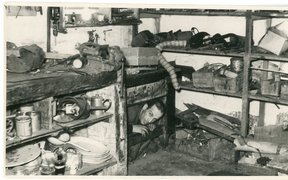 David Zivcon in the hiding place, Liepāja, 1944. The basement contained an emergency hiding place separated off by a wall. The small entrance was underneath a workbench.